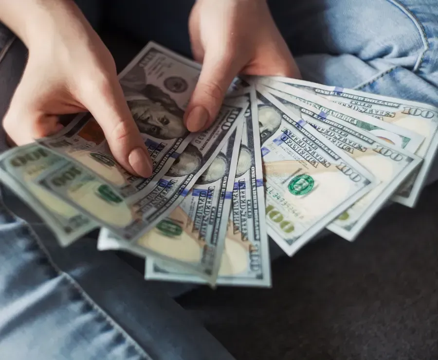 Girl holding American Dollar Bills