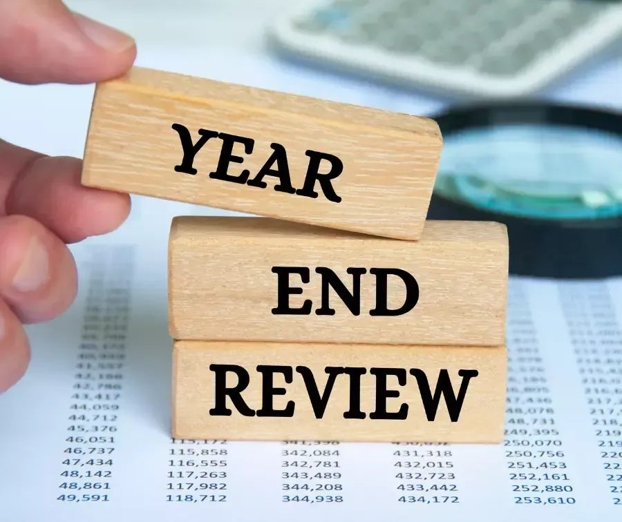 Year end review text on wooden blocks.