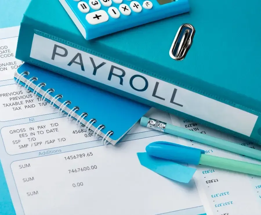 Blue Payroll folder with payslip and blue notebook and pen.
