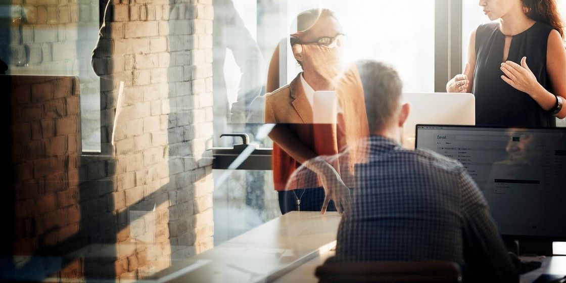 A group of people are having a meeting in an office.