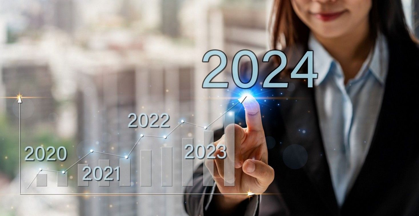 A woman is pressing a button on a screen that says 2024.