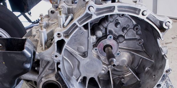 A close up of a car engine with the gearbox removed.