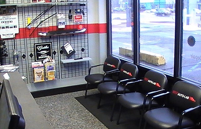 A waiting room with black chairs and a sign that says brake