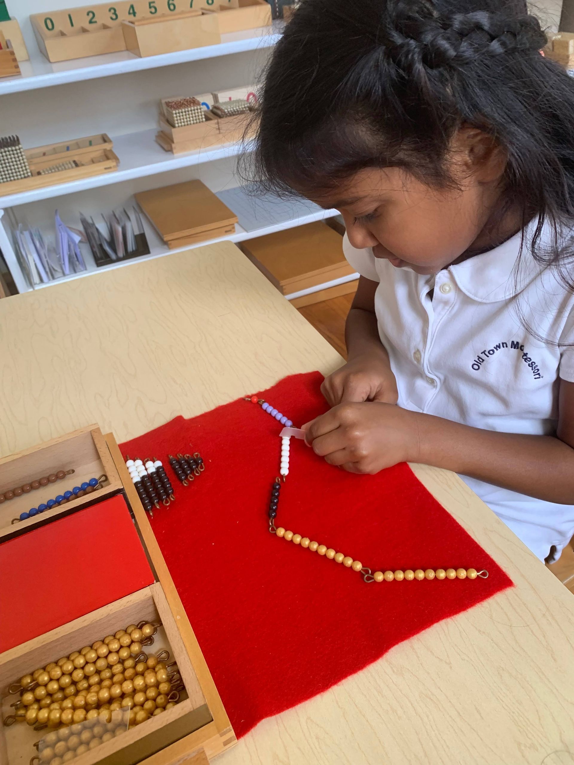 Montessori child working montessori math materials