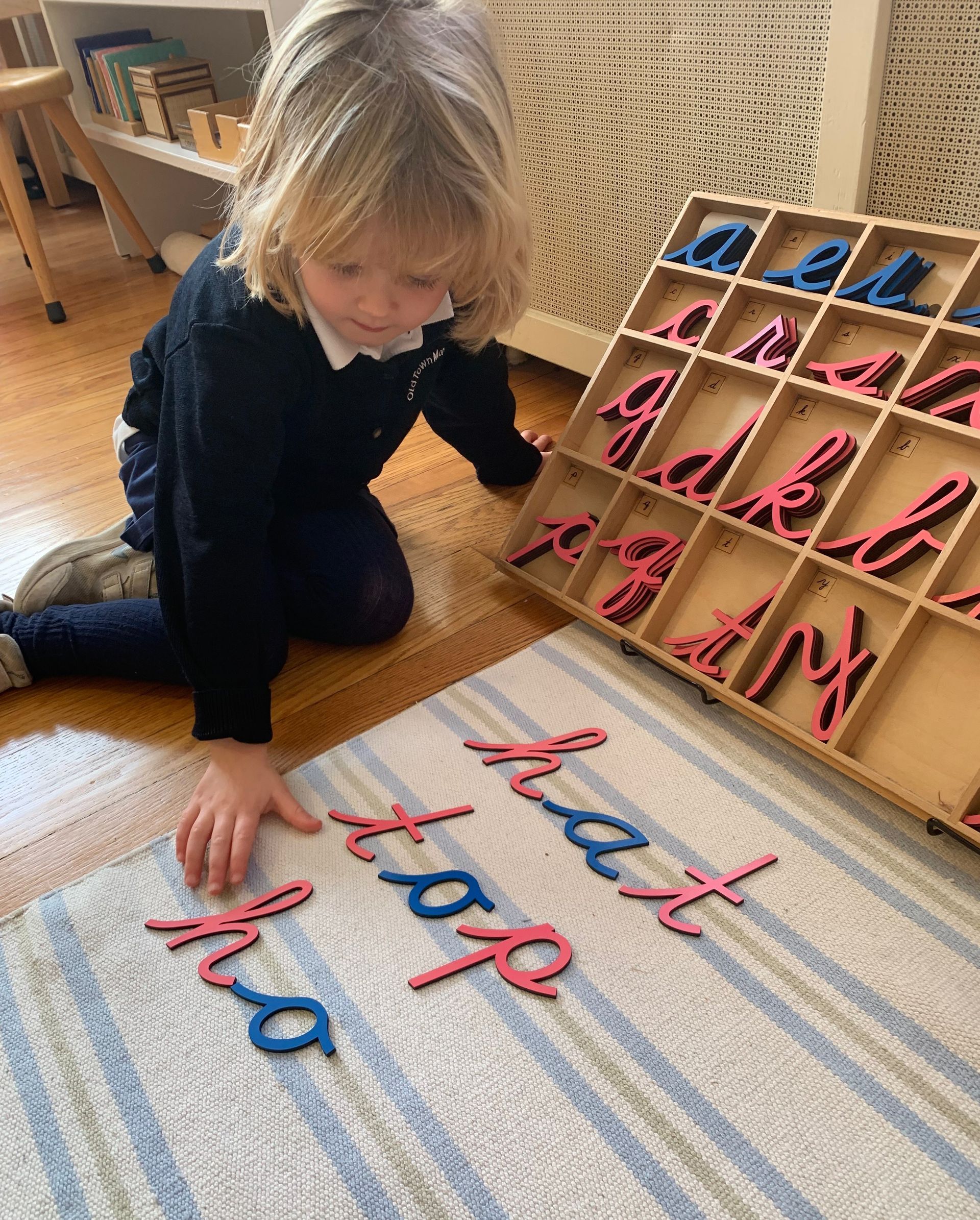 Montessori child working with montessori languaje materials