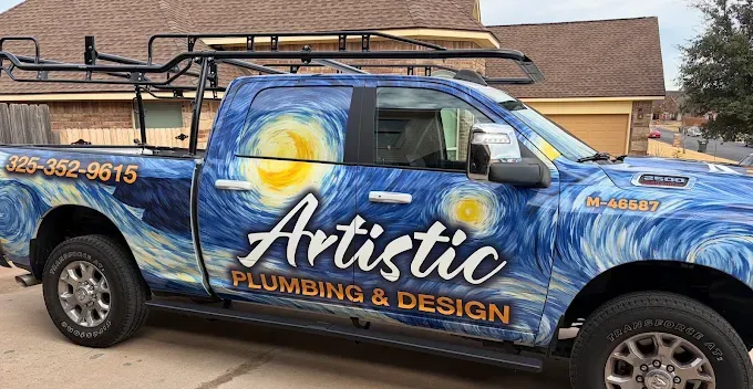Blue Artistic Plumbing & Drains pickup with a large bunny decal, parked in a lot under cloudy skies