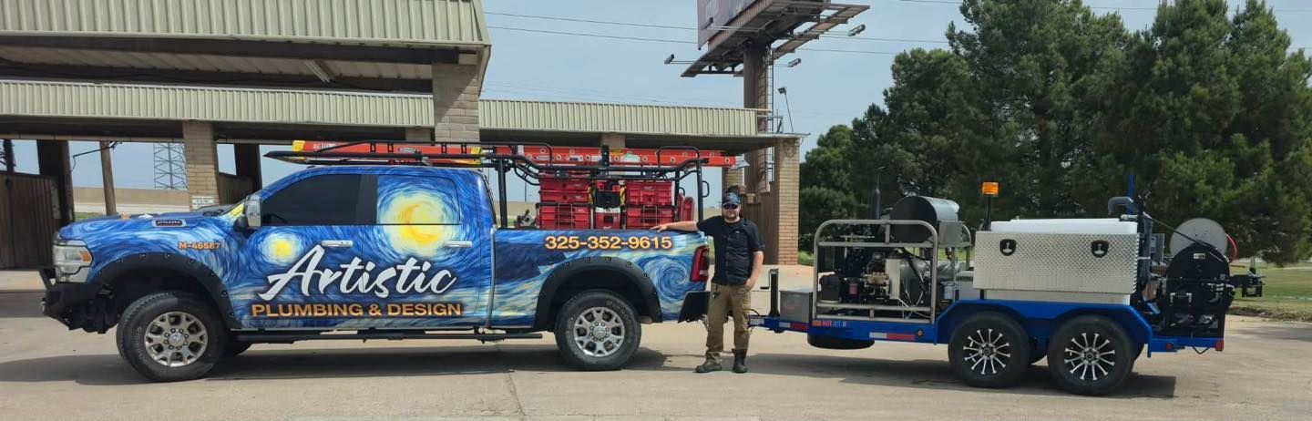 Blue team truck and trailer parked outdoors beside a building, with two people standing nearby.