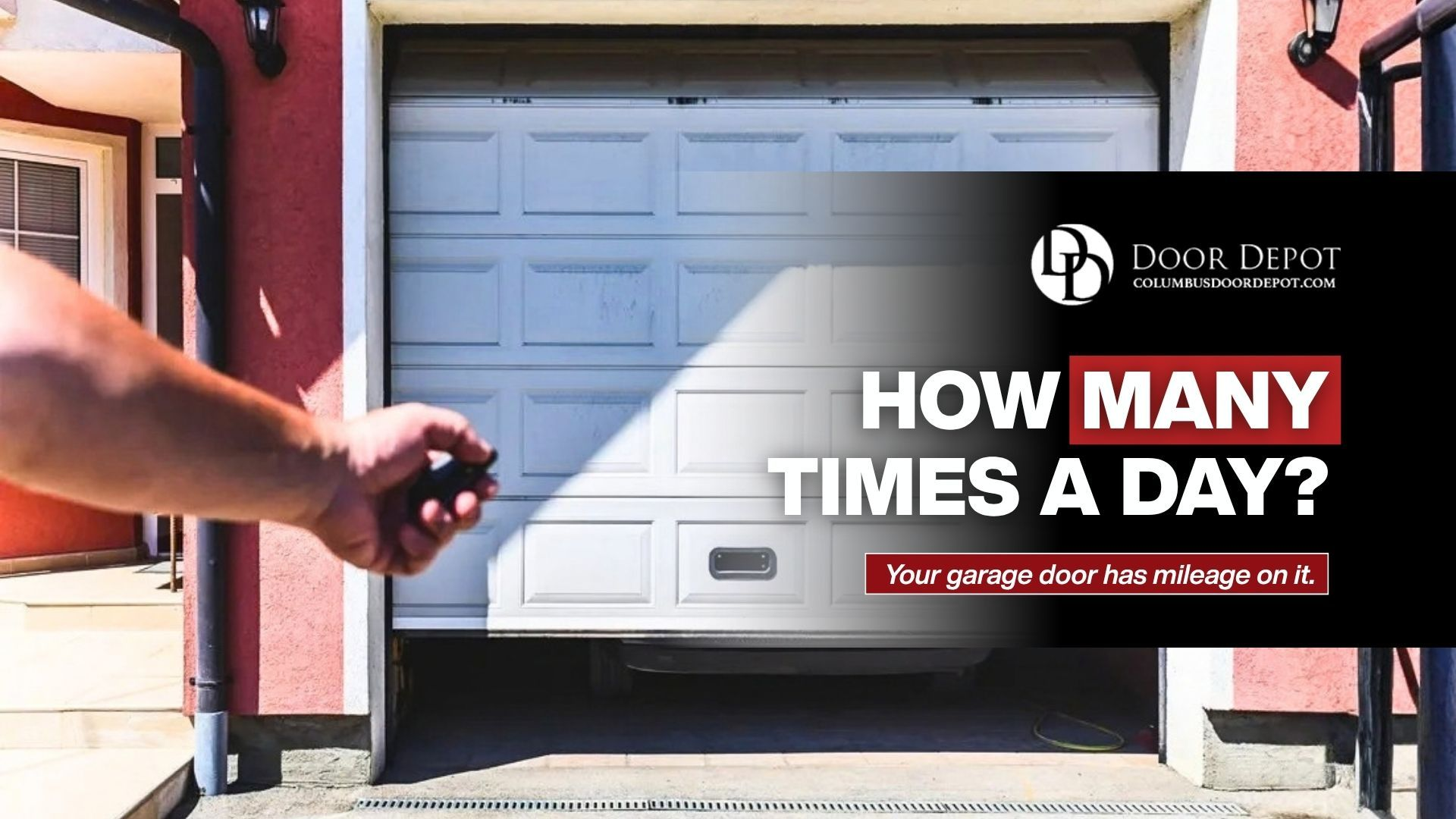 Hand using a remote to open a garage door in Columbus