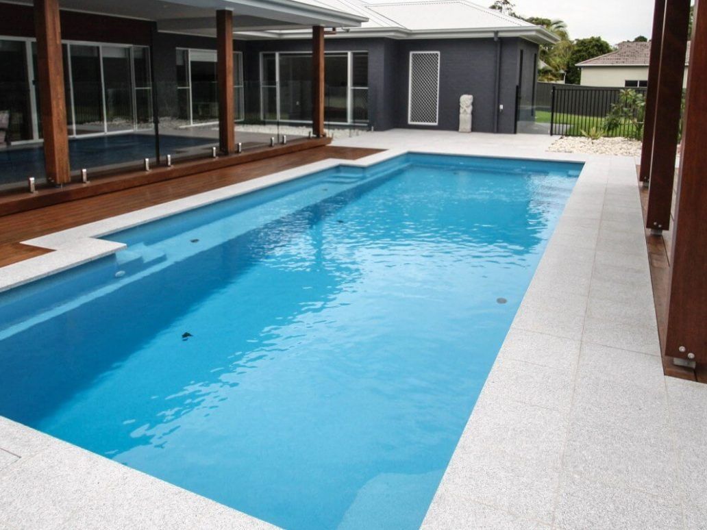 A Large Swimming Pool in Front of a House — Azure Pools Mid North Coast In Diamond Beach, NSW