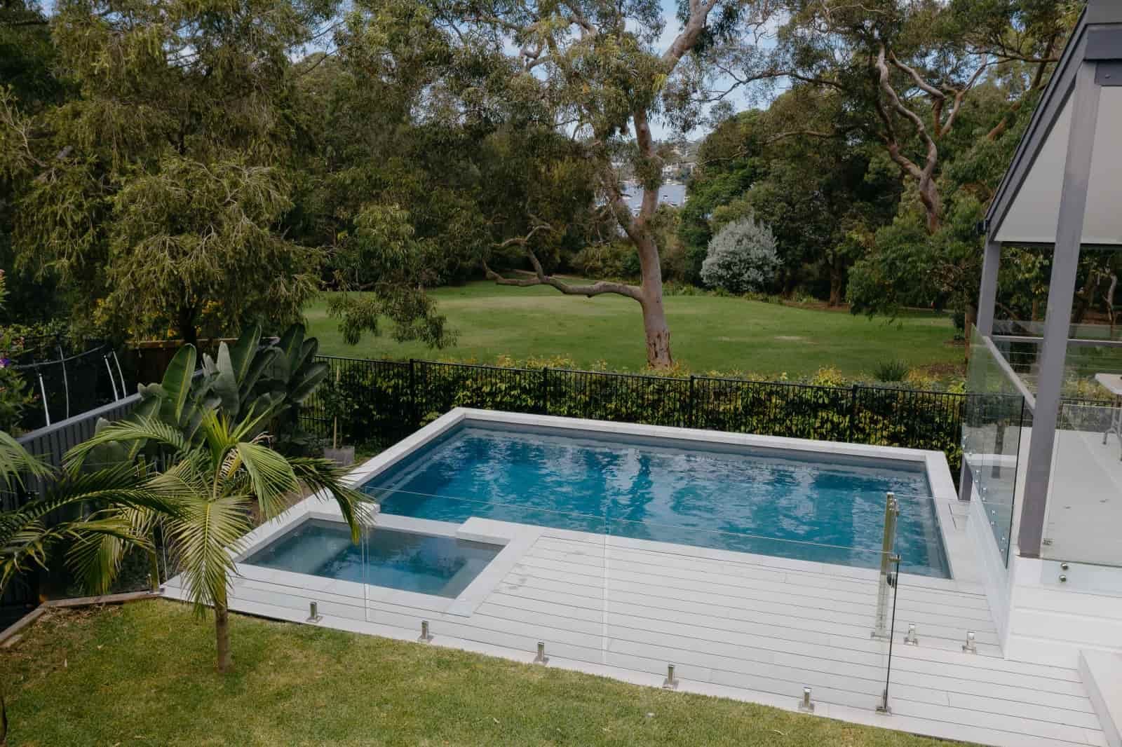 An Aerial View of a Large Swimming Pool in the Backyard of a House — Azure Pools Mid North Coast In Gloucester, NSW
