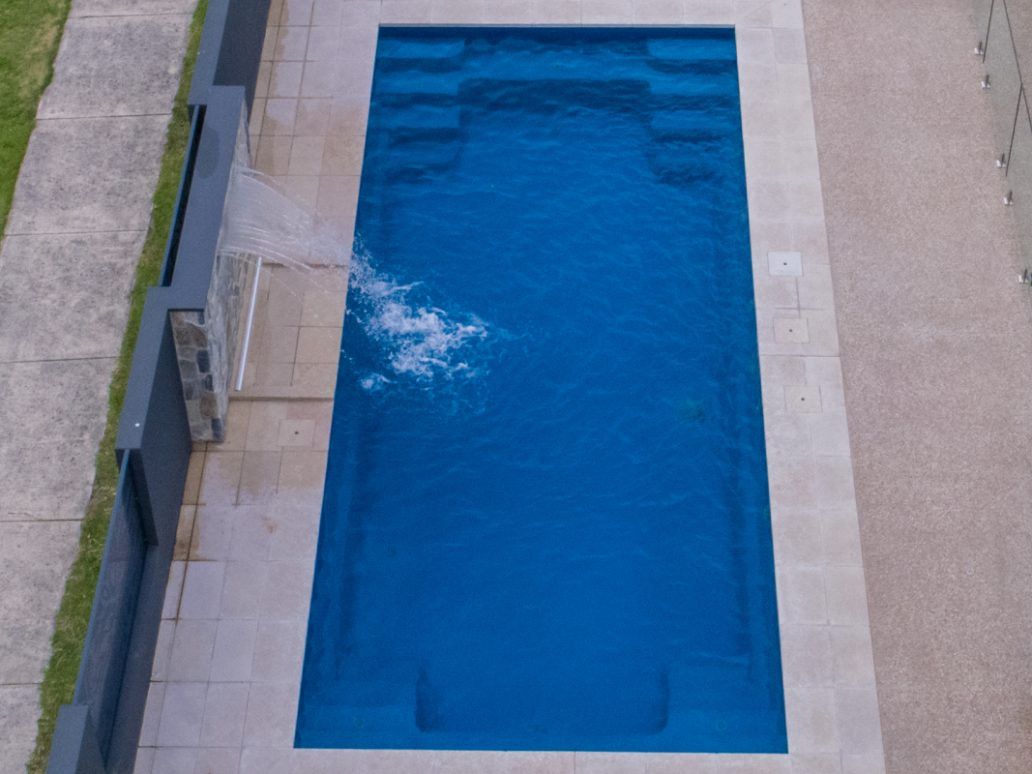An Aerial View of a Large Blue Swimming Pool — Azure Pools Mid North Coast In Forster, NSW