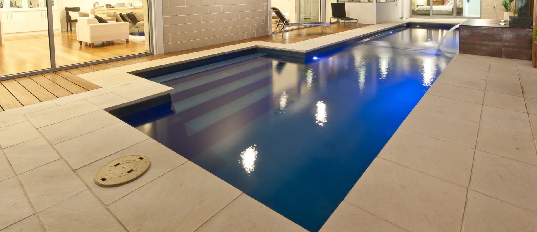 A Large Indoor Swimming Pool With Blue Lights on It — Azure Pools Mid North Coast In Forster, NSW