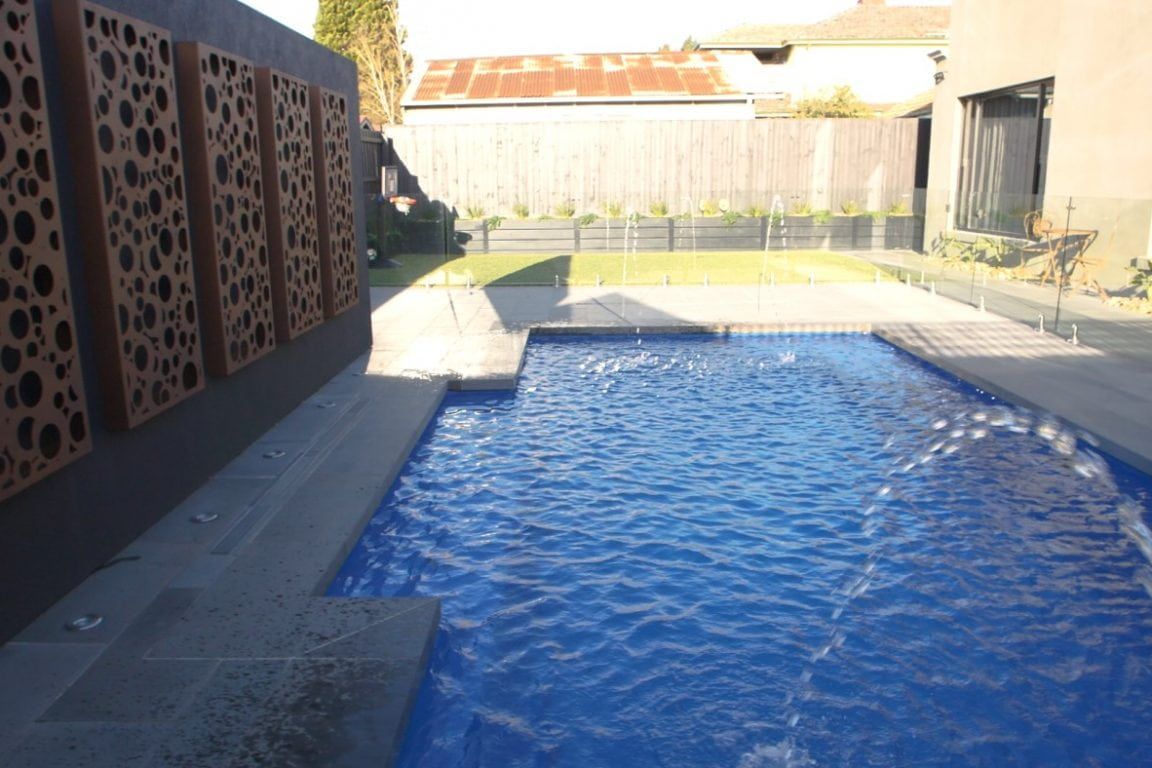 A Large Swimming Pool in the Backyard of a House — Azure Pools Mid North Coast In Old Bar, NSW