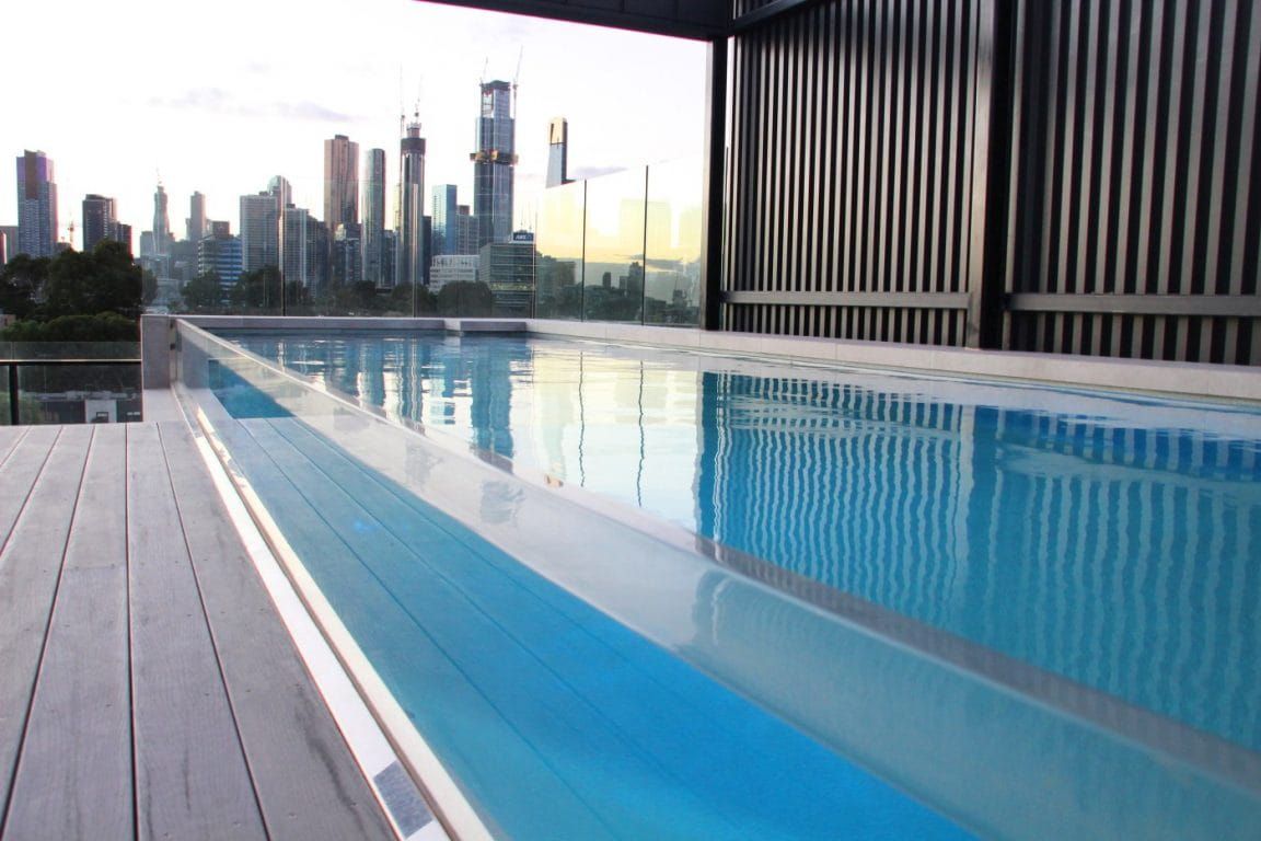 A Swimming Pool With a City Skyline in the Background — Azure Pools Mid North Coast In Nabiac, NSW