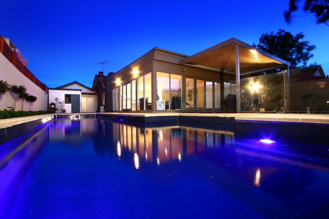 A House With a Large Swimming Pool in Front of It — Azure Pools Mid North Coast In Nabiac, NSW