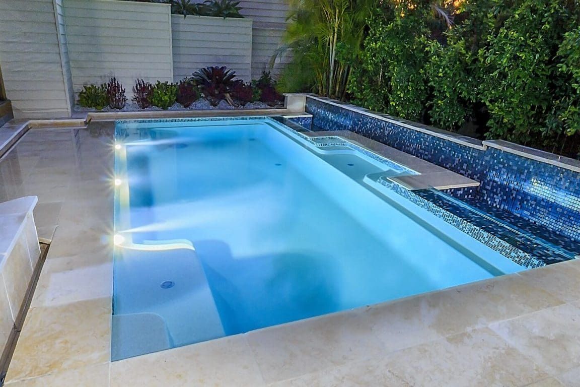 A Large Swimming Pool With a Waterfall in the Middle of It — Azure Pools Mid North Coast In Old Bar, NSW