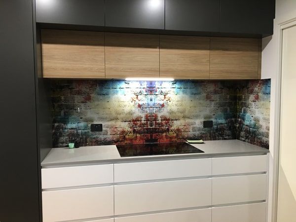 A Kitchen With a Stove Top Oven and a Brick Wall Behind It — DecoGlaze in Camden, NSW