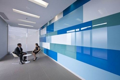 A Man and a Woman Are Sitting at a Table in Front of a Blue Wall — DecoGlaze in Minchinbury, NSW