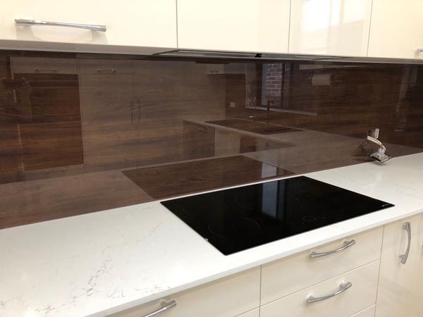 A Kitchen With White Cabinets and a Black Stove Top Oven — DecoGlaze in Penrith, NSW