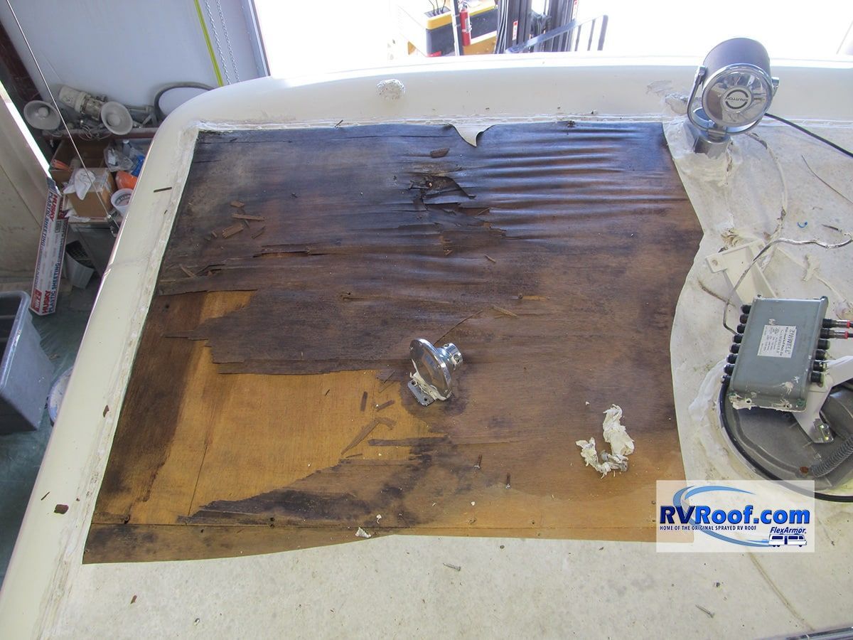 RV roof damage showing wood particle.