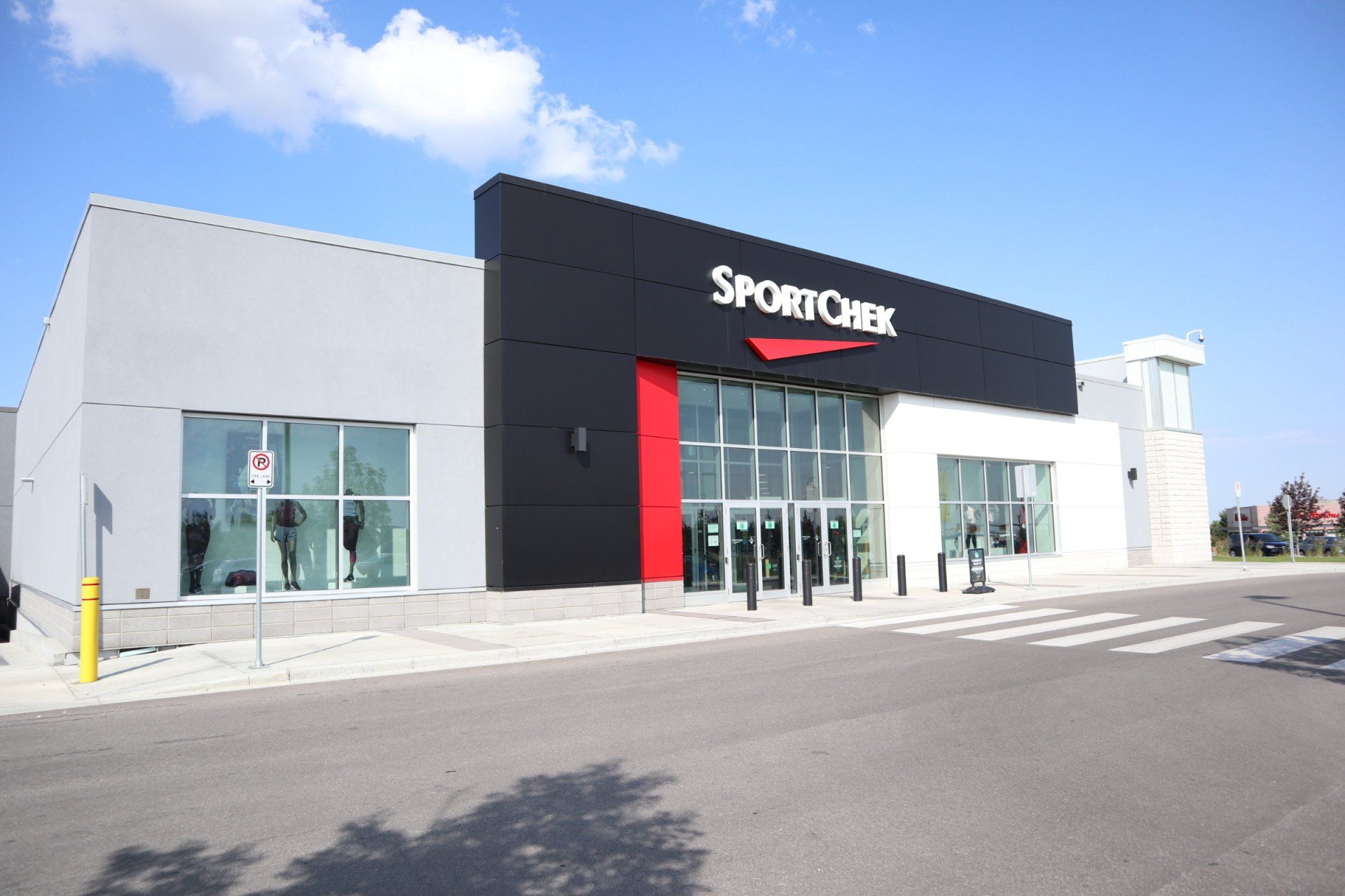 the front of a sportchek store with a blue sky in the background