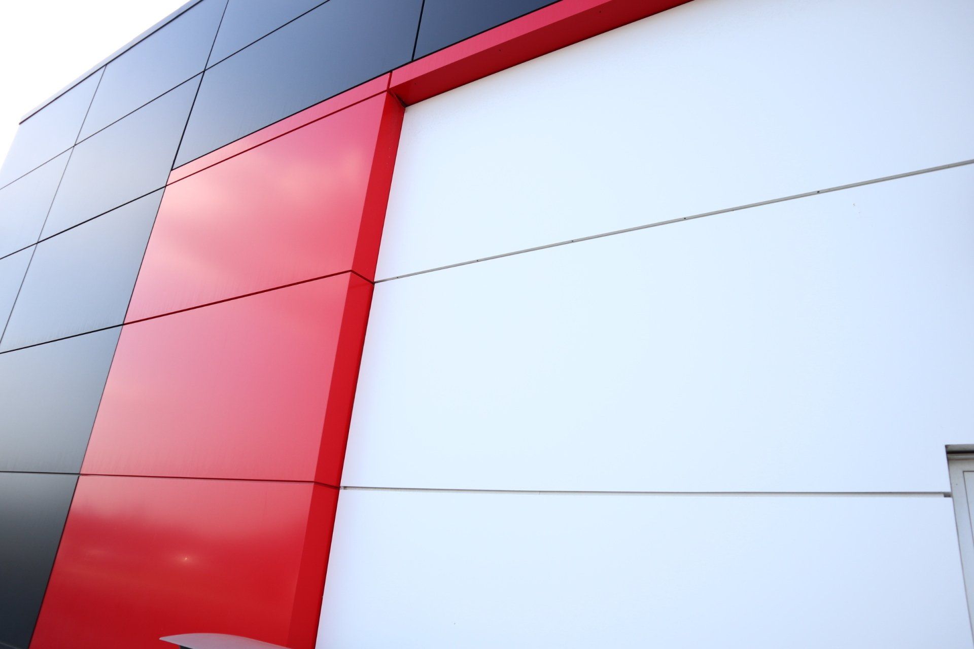 a red white and black building with a white door