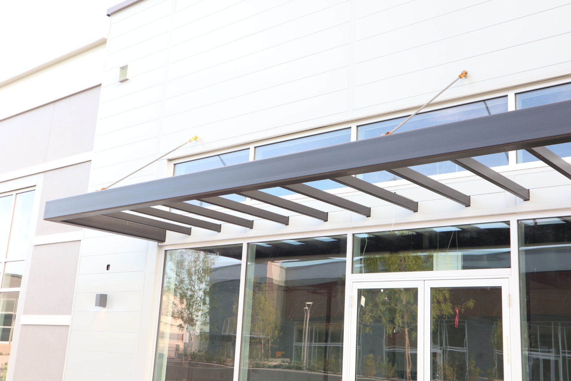 a white building with a canopy over the entrance