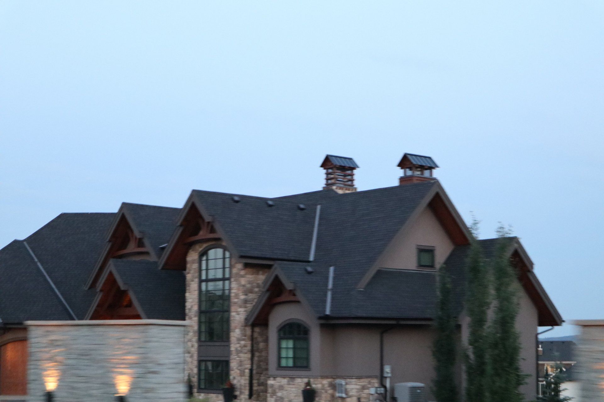 a large house with two chimneys on the roof