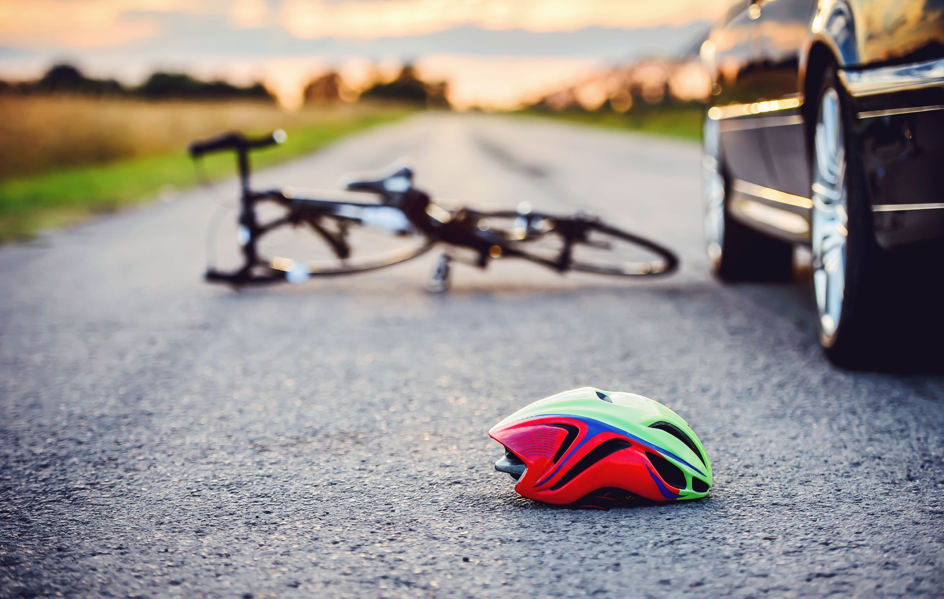 Bicycle and helmet on road after collision with a car