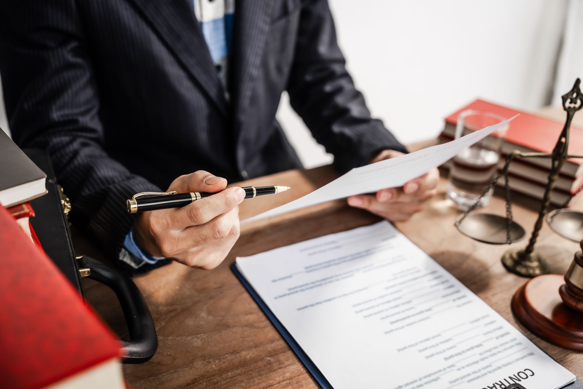 Lawyer in suit reviewing documents.