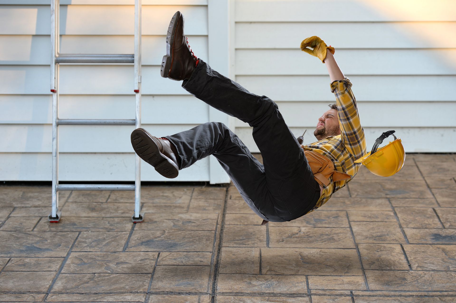 Construction worker falling from a ladder.