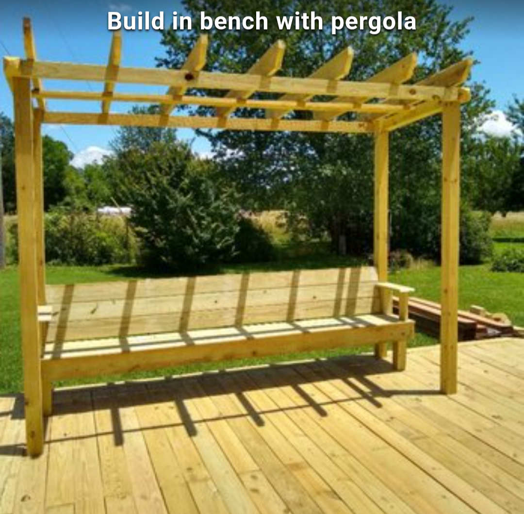 Wooden built-in bench with pergola on a sunny deck, overlooking a grassy yard
