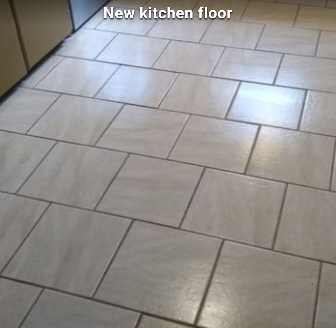New beige tiled kitchen floor with staggered rectangular tiles and visible grout lines