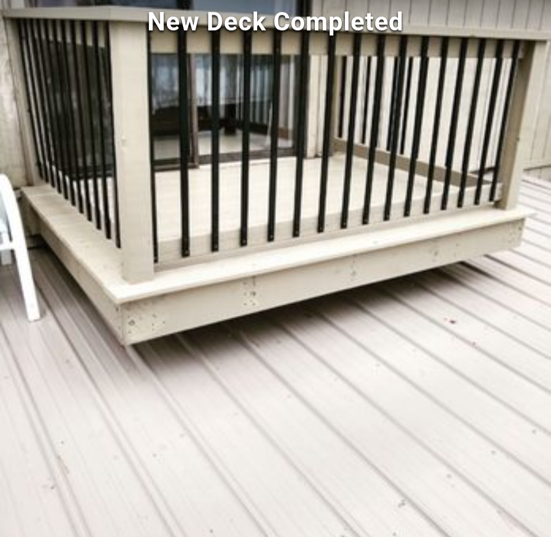 New wooden deck with white railing beside a light gray patio