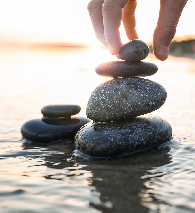 woman's hand stacking rocks