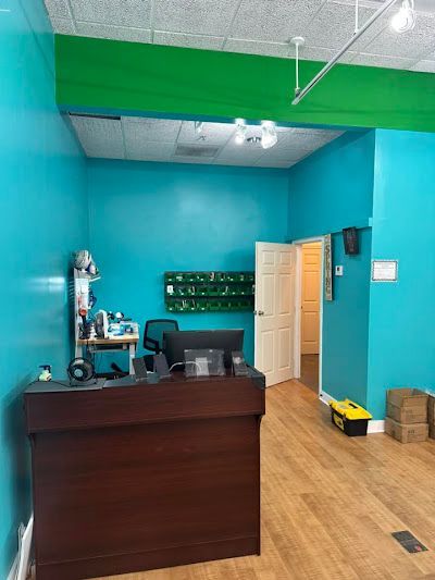 A room with blue walls and a desk with a computer on it.