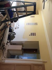 A room with a ladder in the middle of it.