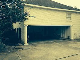 There is a garage with a bicycle parked in it.