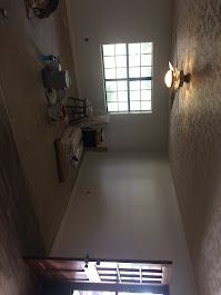 A room with a ceiling fan and a window.