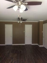There is a ceiling fan in the corner of the room.