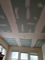 A room with a ceiling that is being remodeled.