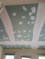 A room with a ceiling that is being remodeled.