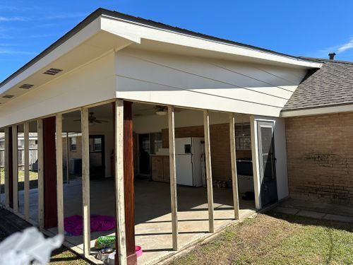 A house with a covered patio and a kitchen in the backyard.