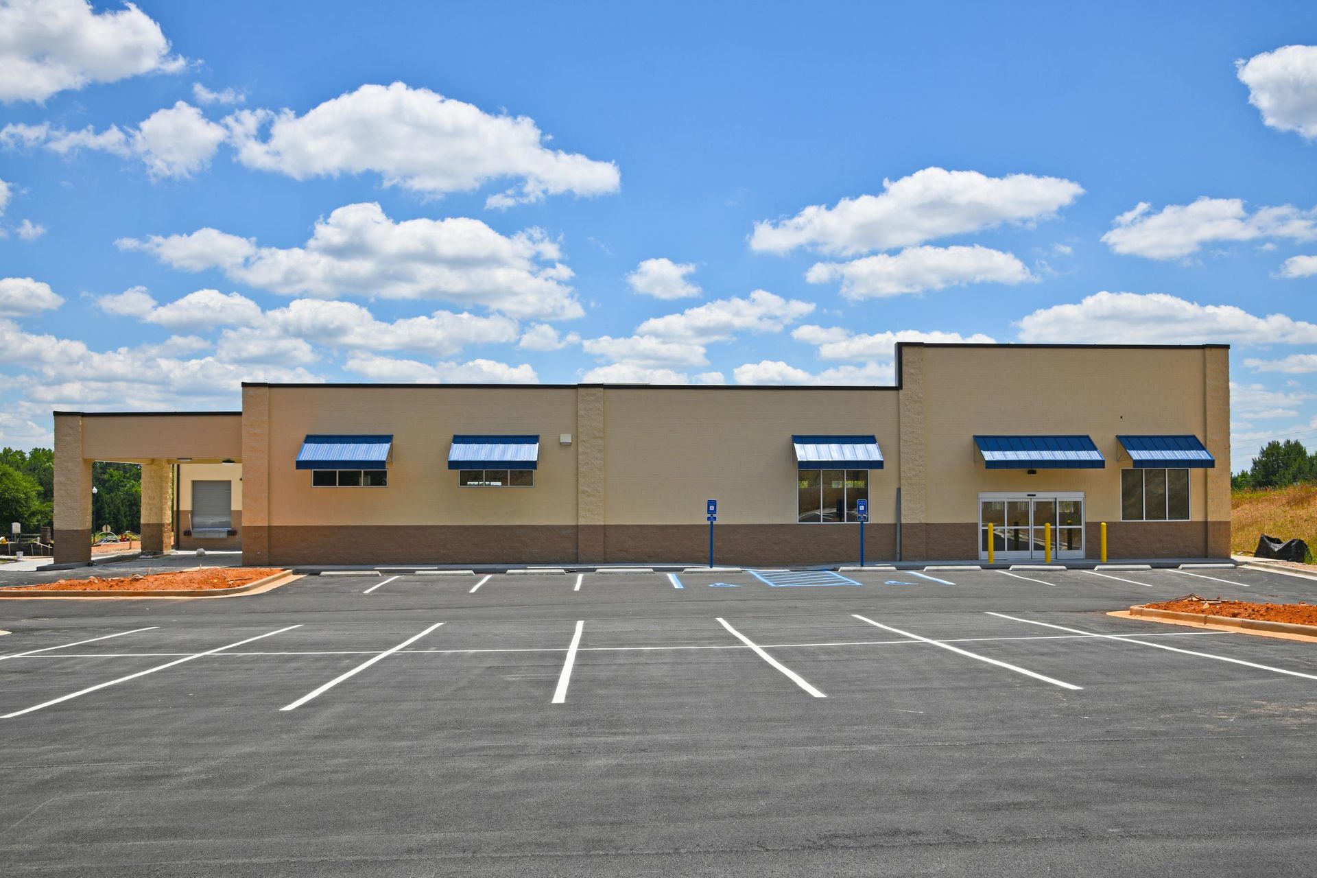 An empty parking lot in front of a building.