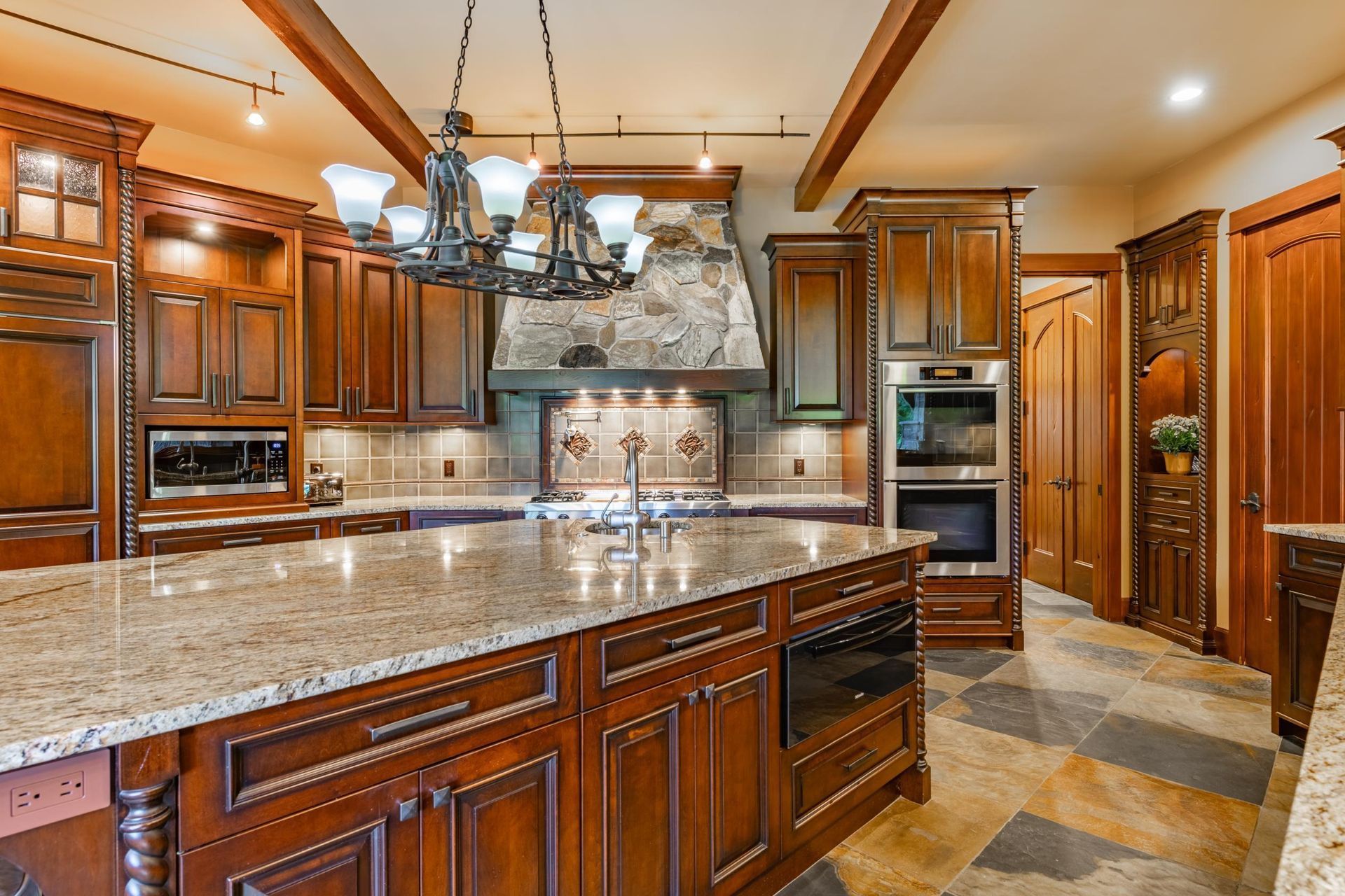 A large kitchen with wooden cabinets and granite counter tops.