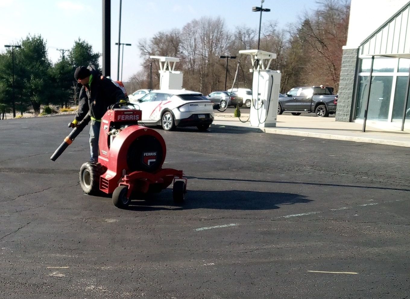 A person is raking a lawn with a rake.