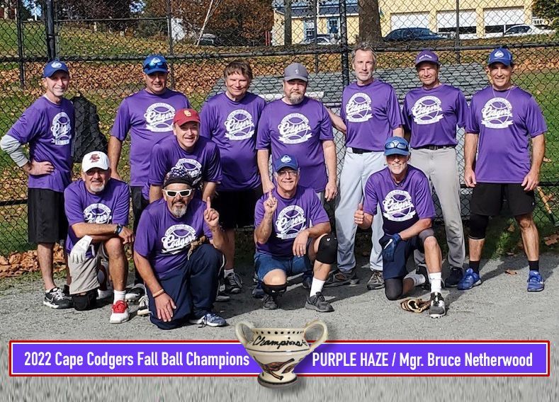 The Cape Codgers Fall Ball champions, a team in matching purple shirts, pose for a group photo on a baseball field.
