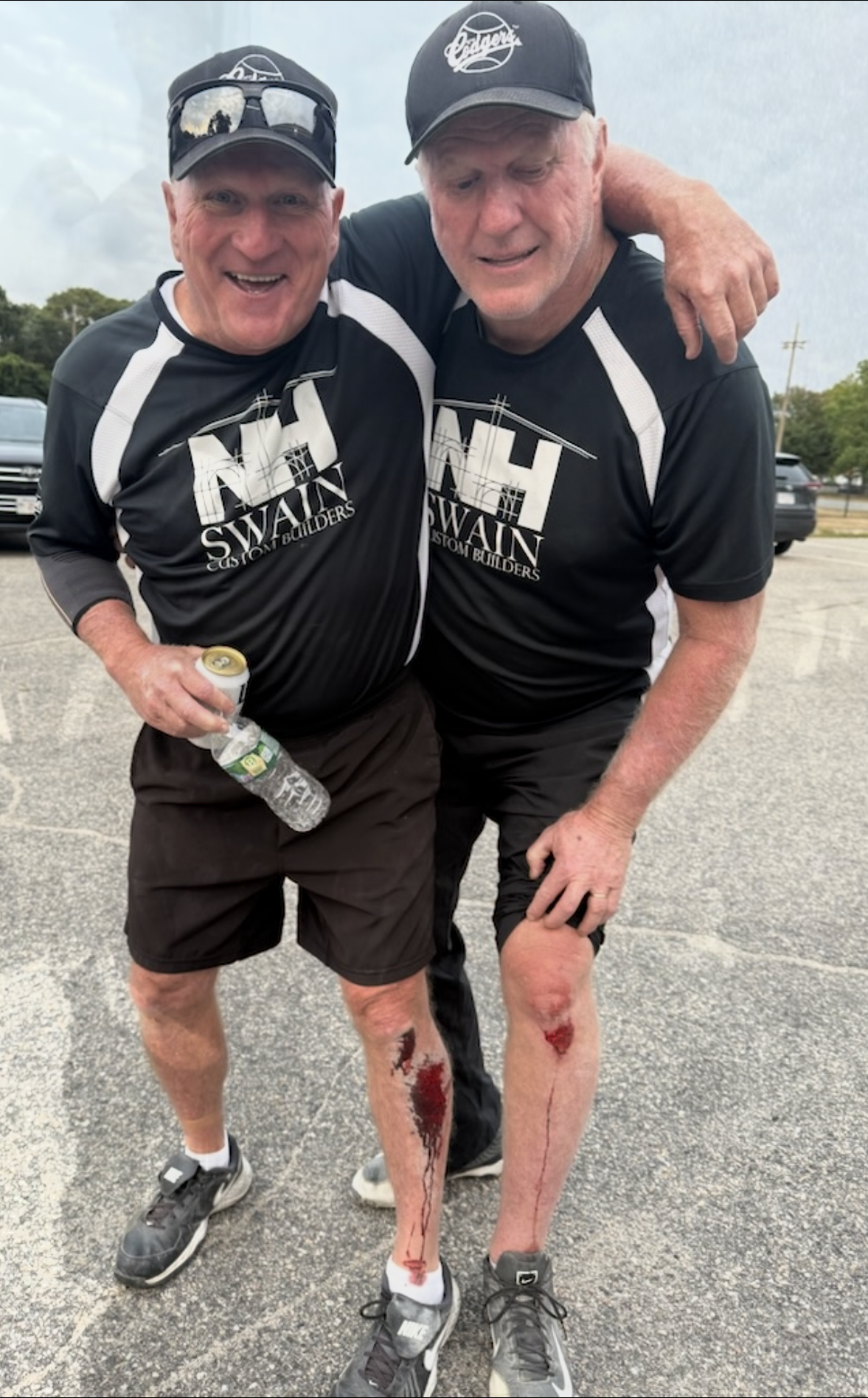 Two smiling individuals wearing matching shirts with