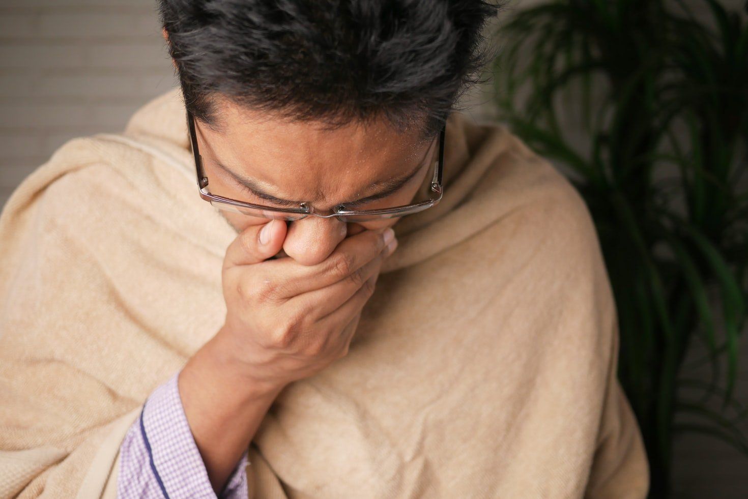 man covering mouth