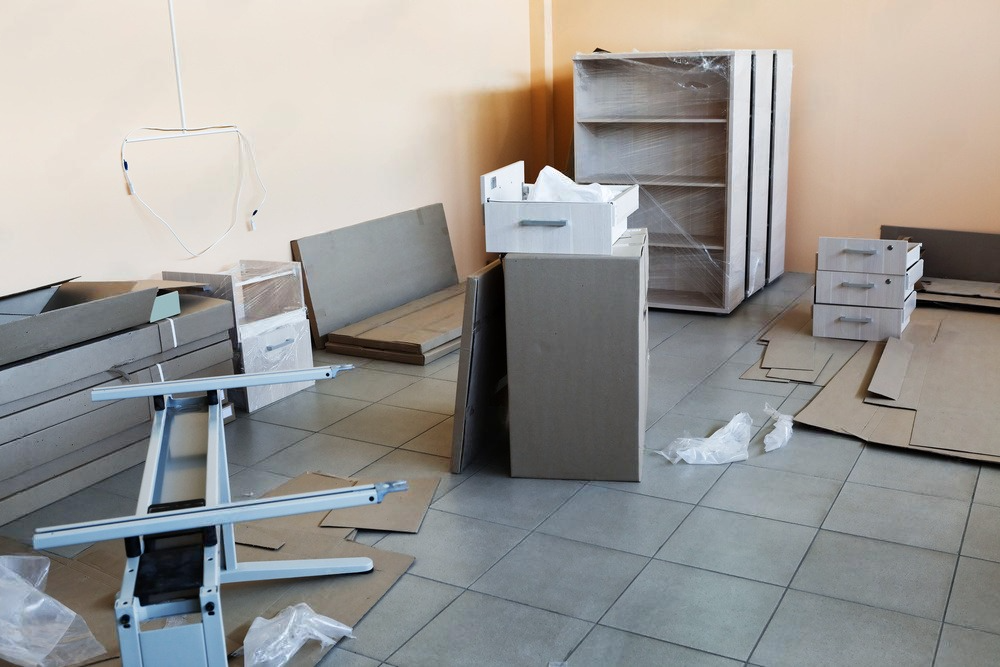 a room with a lot of cardboard boxes on the floor .